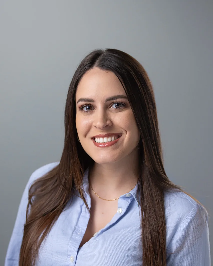 Professional headshot of a businesswoman against a neutral gray backdrop