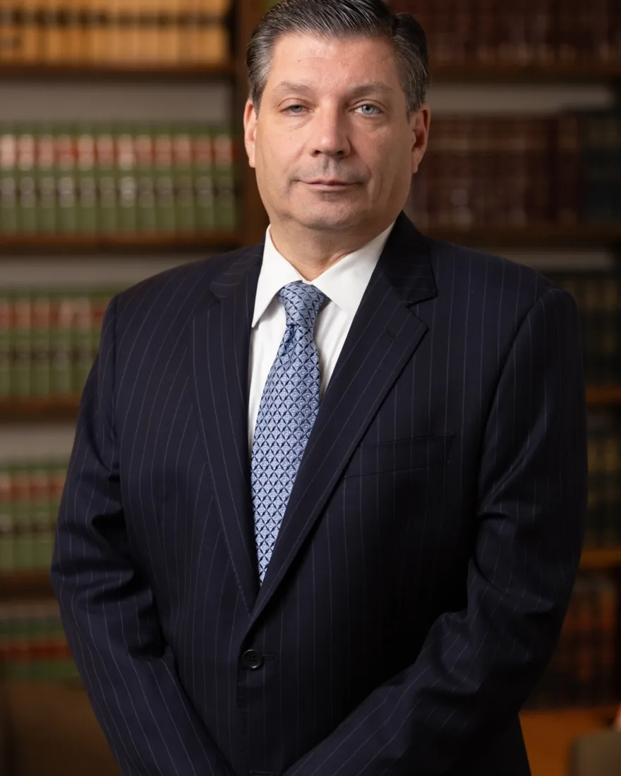 Executive in a suit in front of law library shelves