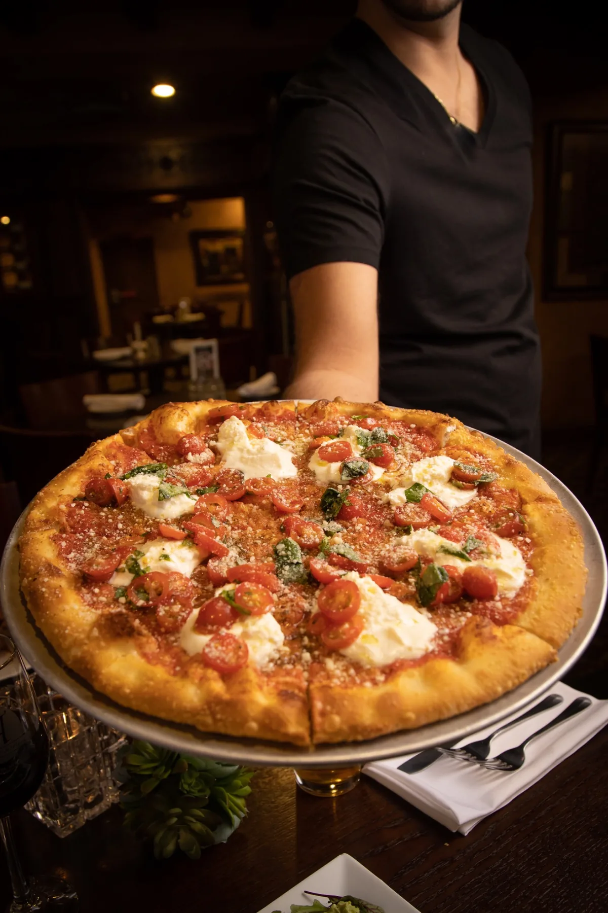 Freshly prepared artisan pizza photographed inside a restaurant
